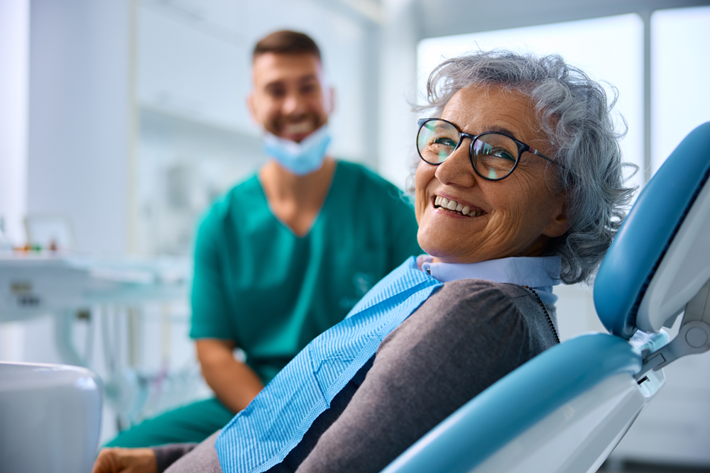 Senior patient smiling in dental chair during appointment