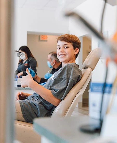 Young patient smiling in a dental chair during a general dentistry visit at a Kanata dental clinic